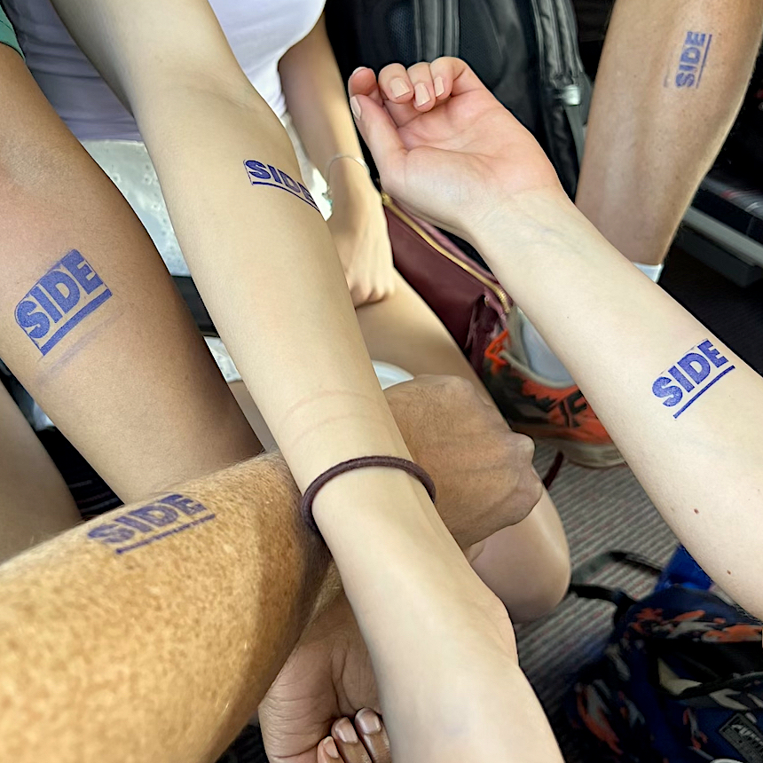 Image of arms with stamps that read SIDE